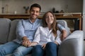 Beautiful married couple rest on couch pose looking at camera Royalty Free Stock Photo