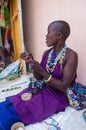Beautiful masaai woman weaving necklace Royalty Free Stock Photo