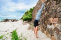 Beautiful mature aged woman doing yoga on a desert tropical beach Royalty Free Stock Photo