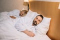 beautiful mature couple in bathrobes sleeping together Royalty Free Stock Photo