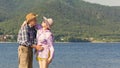 Beautiful mature couple hugging and kissing on a sandy beach on a summer sunny day Royalty Free Stock Photo