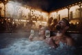 Beautiful mature couple relaxing in outdoor hot tub, drinking champagne, enjoying romantic wellness weekend in spa Royalty Free Stock Photo