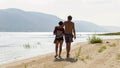 A beautiful mature couple walks along the wild beach holding hands against the background of the Volga open spaces and the Zhiguli Royalty Free Stock Photo