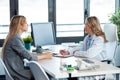 Beautiful mature female doctor talking while explaining medical treatment to patient in the consultation Royalty Free Stock Photo