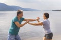 Beautiful mature sportive couple doing gymnastic exercises on the beach Royalty Free Stock Photo