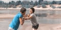 Beautiful mature sportive couple doing gymnastic exercises on the beach Royalty Free Stock Photo