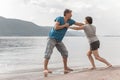 Beautiful mature sportive couple doing gymnastic exercises on the beach Royalty Free Stock Photo