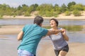 Beautiful mature sportive couple doing gymnastic exercises on the beach Royalty Free Stock Photo