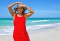 Beautiful Mature Woman on Beach Wearing a Red Dress Royalty Free Stock Photo