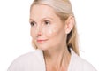 beautiful mature woman with cosmetic cream on face Royalty Free Stock Photo