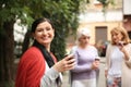 Beautiful mature woman and her friends drinking coffee outdoors Royalty Free Stock Photo