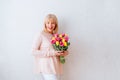 Beautiful mature woman holding tulips. Royalty Free Stock Photo