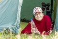 Beautiful mature woman lies in a tent and holds a bottle of pure mineral water Royalty Free Stock Photo