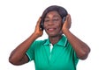 Mature woman listening to music with her wireless headphones smiling