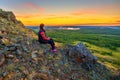 A beautiful mature woman meets the dawn on the Nurali ridge