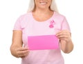 Beautiful mature woman with pink ribbon holding card on white background. Breast cancer concept Royalty Free Stock Photo