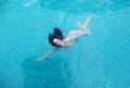 Beautiful mature woman in the prime age with dark curly hair in a bikini is running floating weightless elegant happy floating