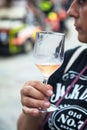 Woman tasting a glass of white sparklig wine. Color image