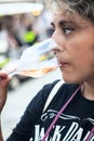 Woman tasting a glass of white sparklig wine. Color image