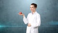 Beautiful medical woman doctor in uniform. Studio painted background. Concept of profitable health care.