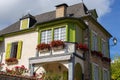 Beautiful medieval house with stone fence, garden and street lamp. Nice village street in France. Residential cottage with flowers Royalty Free Stock Photo