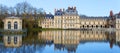 Beautiful Medieval landmark - royal hunting castle Fontainbleau with reflection in water of pond. Royalty Free Stock Photo