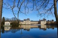 Beautiful Medieval landmark - royal hunting castle Fontainbleau with reflection in water of pond. Royalty Free Stock Photo