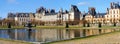 Beautiful Medieval landmark - royal hunting castle Fontainbleau with reflection in water of pond. Royalty Free Stock Photo