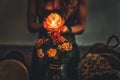 beautiful meditating woman with lotus candle in her hand and djembe.