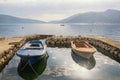 Beautiful Mediterranean landscape on foggy spring day. Fishing boats in small harbor. Montenegro, Kotor Bay