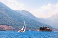 Beautiful Mediterranean landscape. Montenegro, Kotor Bay. Sailboat sails near Island of St. George