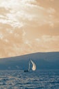 Beautiful Mediterranean landscape and sailboat on water. Toned image Royalty Free Stock Photo