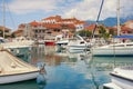 Beautiful Mediterranean landscape. Seaside town: houses with red roofs and fishing boats in harbor. Montenegro, Tivat city Royalty Free Stock Photo