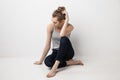 Beautiful melancholic girl sitting on the floor