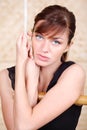 Beautiful melancholy woman holds on bamboo rope ladder. Royalty Free Stock Photo