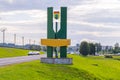 A beautiful memorial sign on the background of a long road and a small town