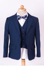 Beautiful men`s blue jacket suit with shirt and bow tie on white background Royalty Free Stock Photo