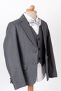 Beautiful men`s grey jacket suit with shirt and bow tie on white background Royalty Free Stock Photo