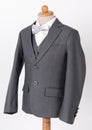 Beautiful men`s grey jacket suit with shirt and bow tie on white background Royalty Free Stock Photo