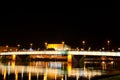 Beautiful mesmerizing night scene panoramic view of Linz Nibelungen bridge over Danube river with golden lights colorful reflexion