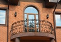 Beautiful metal balcony on brick house exterior