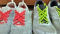 Beautiful method of Shoelace tying. Colorful neon pink and lime green shoelaces on white sneakers