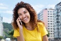 Beautiful mexican girl at phone outdoor in city Royalty Free Stock Photo