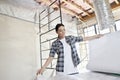 Beautiful mid adult contractor looking at building plans at construction site Royalty Free Stock Photo