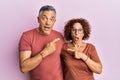 Beautiful middle age couple together wearing casual clothes surprised pointing with finger to the side, open mouth amazed Royalty Free Stock Photo