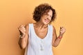 Beautiful middle age mature woman wearing casual clothes very happy and excited doing winner gesture with arms raised, smiling and Royalty Free Stock Photo