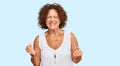 Beautiful middle age mature woman wearing casual white shirt very happy and excited doing winner gesture with arms raised, smiling Royalty Free Stock Photo