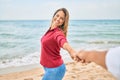 Beautiful middle age woman holding hands with husband at the beach, leading the way happy smiling in love Royalty Free Stock Photo