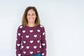 Beautiful middle age woman wearing heart sweater over isolated background with a happy and cool smile on face