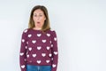 Beautiful middle age woman wearing heart sweater over isolated background In shock face, looking skeptical and sarcastic,